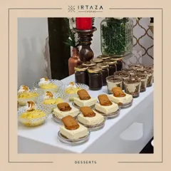 A beautiful spread of modern desserts, including individual Lotus Biscoff cheesecakes and lemon meringue tarts. This station offers a sophisticated selection for guests with a contemporary palate.