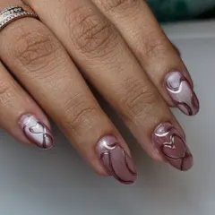 Magnetic charm with a touch of love. This design uses a shimmery cat-eye polish as a base for delicate, 3D chrome hearts and swirls.