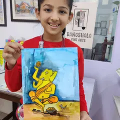 A young artist holds her colorful watercolor of Lord Ganesha, painted as part of our festive class activities.