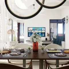 A 3D visualization of a dining area that opens up to the living room. This render helped the client envision the final look, featuring modern circular light fixtures and a clean, bright aesthetic that connects the spaces.