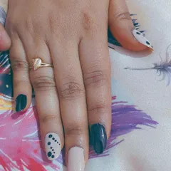 A chic and modern design that's great for the office or a trip. This look uses a mix of solid black, nude, and a nude accent nail with a simple black dot pattern.