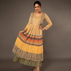 A dynamic full-length shot of a model in a layered Anarkali, showcasing the outfit's flow and intricate patterns with a confident pose.