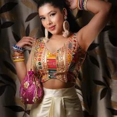 For a fun and modern Mehendi look, I paired a colorful, mirror-work blouse with a comfortable satin dhoti skirt. This fusion outfit is easy to move in and looks incredibly festive, especially with the right accessories like a potli bag.