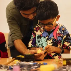 Our robotics teacher guides a student through the intricate process of building a robot. This one-on-one attention helps children grasp complex concepts and build confidence in their abilities.