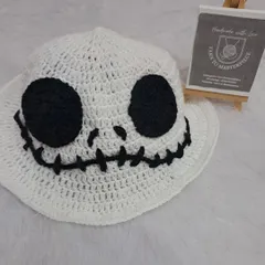 Getting ready for Halloween with this spooky-fun ghost hat. Inspired by Jack Skellington, this white bucket hat features a stitched smile and big black eyes.