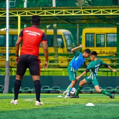 Theory meets practice. A coach from our AIFF D-License course applies their learning by instructing our youth players in a real-time training drill, a core part of their certification.