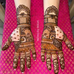 A symmetrical bridal design featuring classic Rajasthani architecture and peacock motifs. The use of negative space makes the central figures stand out beautifully.