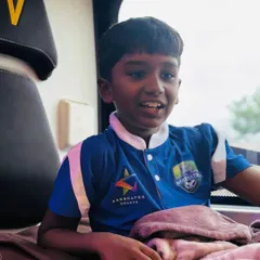 The excitement is real. A young player smiles as he sits on the bus, ready for the journey to Ahmedabad to represent Bangalore.