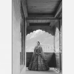 A stunning black and white portrait of the bride on a balcony, the majestic mountains serving as a dramatic and timeless backdrop.