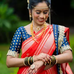 A candid moment showing the bride's joy. Her soft glam makeup, with a focus on a flawless base and defined eyes, ensures she looks perfect from every angle throughout the wedding ceremonies.