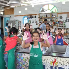 The joy of getting your hands messy with flour! We encourage kids to dive into the cooking process, making learning fun and interactive.