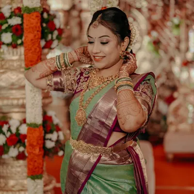A beautiful South Indian bride adjusting her jewelry, a classic and elegant portrait from her wedding day.