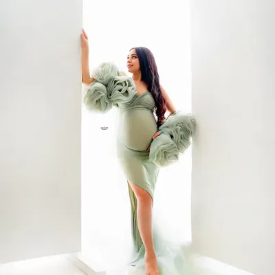 A stunning high-key portrait using our mint green tossing fabric. The way the light comes through the doorway creates a beautiful, ethereal glow.