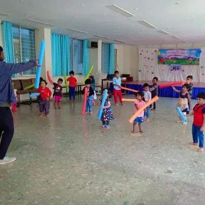 We use props like soft pool noodles for fun aerobic exercises. This activity helps improve coordination and cardiovascular fitness while feeling like a playful sword fight.