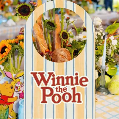 A custom sign for a Winnie the Pooh themed party, with a unique centerpiece combining fresh baguettes and sunflowers.