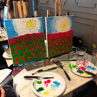 Two finished canvases side-by-side, showcasing a textured field of red poppies under a bright sun. You can see the thick acrylic paint applied with palette knives to create a 3D effect.