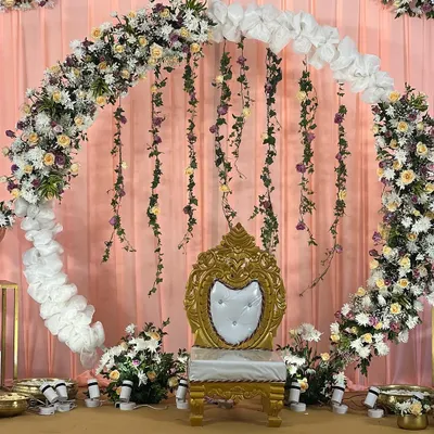 This beautiful floral ring backdrop, with its mix of fresh flowers and hanging vines, creates a perfect stage for intimate celebrations. It's a versatile design that I've customized for two different clients, each time creating a unique and memorable setting.