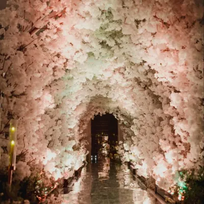 A breathtaking entryway tunnel crafted entirely from white florals. I design these immersive floral installations to create a 'wow' moment for guests, enveloping them in beauty from the moment they arrive.