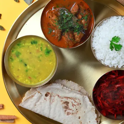 A complete, non-veg thali featuring our home-style chicken curry, dal, beetroot salad, steamed rice, and soft jowar rotis. A perfectly balanced meal to power your day.