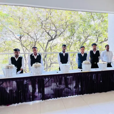 My team of servers standing by the buffet line at Janki Bai Madhvi Hall in Airoli. They are ready and waiting to assist guests during the wedding event.