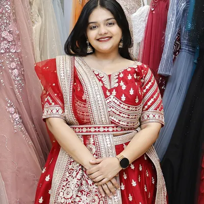 A happy customer trying on a beautiful red lehenga in my store. Her smile says it all.