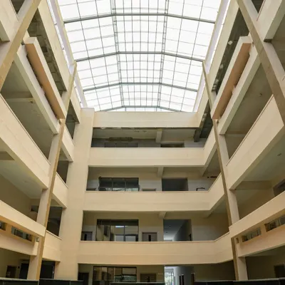 The central atrium at Konark Academy is the heart of the building, designed to foster connection. A massive skylight floods the multi-story space with natural light, creating a bright and airy core that all classrooms open onto.