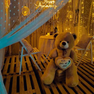 I design intimate and romantic settings like this "Macrame Bliss" anniversary surprise. The warm glow of fairy lights, neon signs, and cozy boho details create a perfect private celebration for two, whether it's on a rooftop or in your backyard.