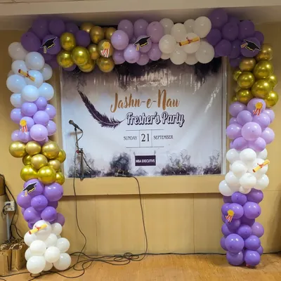 The main stage backdrop for the "Jashn-e-Nau" fresher's party. The balloon arch in college colors and themed cutouts create an exciting focal point for performances and announcements.