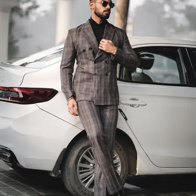 A full-length shot from a men's formal wear series. Posing next to a car adds a lifestyle element to this sharp, tailored look, making it suitable for both fashion portfolios and brand lookbooks.