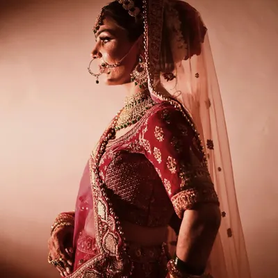 A classic bridal portrait using soft, directional light to create a painterly effect. I focus on capturing the bride's serene expression and the beautiful details of her attire, from the delicate veil to the intricate embroidery.