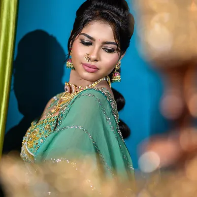 For this semi-traditional engagement look, I focused on creating a soft, romantic mood. The lighting highlights the intricate details on the sea-green lehenga and the delicate jewelry, making it a perfect shot for a makeup artist's bridal portfolio.