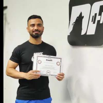 Holding my official CrossFit Level 2 Trainer certificate. This credential was a dream fulfilled and represents my commitment to providing expert-level coaching based on proven CrossFit methodology.