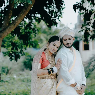 A tender moment between a bride and groom in traditional South Indian wedding attire. I focus on capturing these quiet, unposed interactions amidst the day's celebrations.