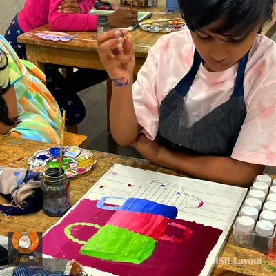 A young artist learns about color blocking and composition. This exercise with stacked cups helps build confidence with the brush and an understanding of basic shapes.