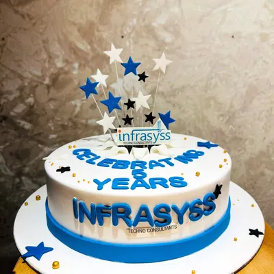 A corporate cake celebrating 8 years of Infrasyss Techno Consultants, featuring the company logo and a star-studded design.