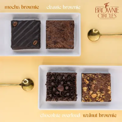 A lineup of our bestsellers, showcasing the variety we offer. From the rich Mocha and Classic brownies to the decadent Chocolate Overload and crunchy Walnut, each one is crafted to be perfectly fudgy.