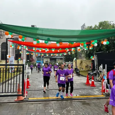 Runners making their way through a decorated route during the DLF Freedom Run, even on a rainy day.