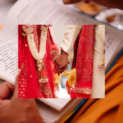 A close-up of the couple holding hands during the ceremony, framed by a holy book. This shot symbolizes their union and the sanctity of the moment.