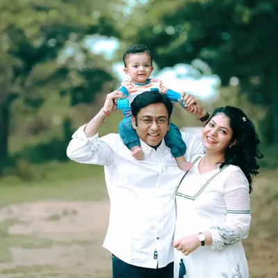 A perfect family portrait. Capturing the joy of a family outdoors, with their little one enjoying a ride on dad's shoulders.