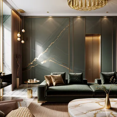 A key feature of this living area is the bookmatched marble wall with gold inlay, creating a stunning focal point. The deep green velvet sofa and warm ambient lighting enhance the room's luxurious and sophisticated character.
