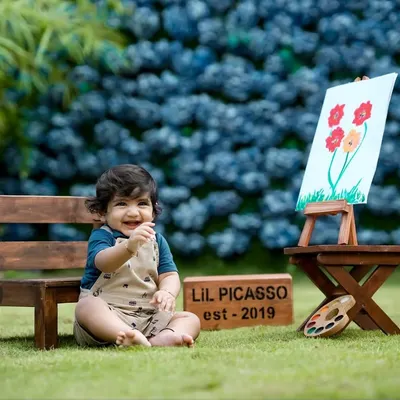Our 'Lil Picasso' theme is a favorite! This little artist is all smiles with his easel and paints in our beautiful garden setting.