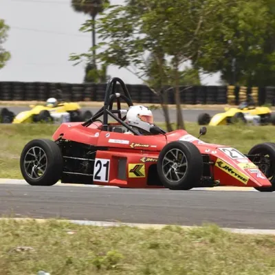 Our Formula LGB car, number 21, on track during a JK Tyre championship race. This program is designed to bridge the gap between elite karting and professional formula racing.