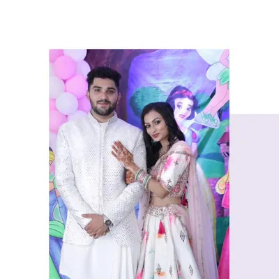 A classic combination for any daytime function. The bride-to-be is in a lovely floral print lehenga, perfectly complemented by the groom's elegant white mirror-work Indo-Western outfit.