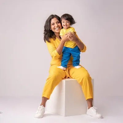 When you can't find the sunshine, be the sunshine. This little guy, at his 9-month milestone session, is pure, happy energy in his bright yellow outfit.