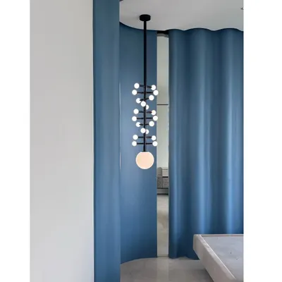 The custom DNA-patterned light fixture, seen here in its final form. This piece is a perfect example of how we use lighting to create a statement and add a sculptural element to a room.