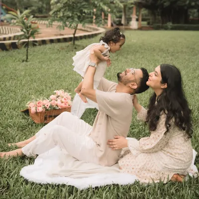 A father joyfully lifting his daughter into the air during an outdoor session. These playful moments create the most authentic photos.
