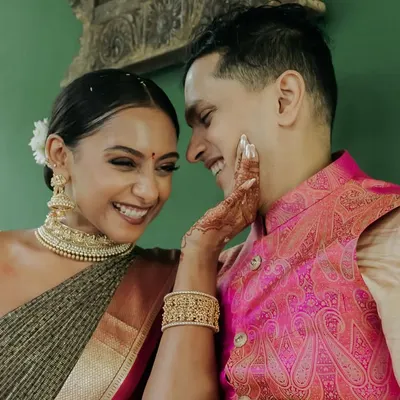 A moment of pure affection. The soft green wall of our suite provides a simple, elegant backdrop that makes the couple's connection the true focus.
