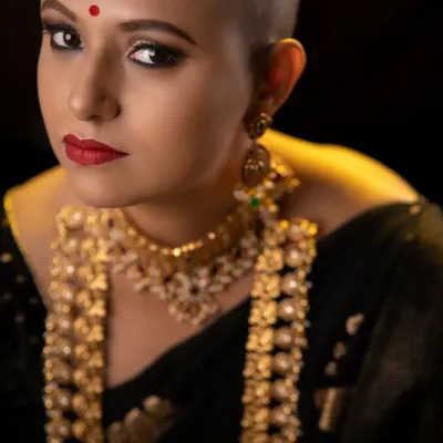 A powerful close-up from my 'Bald, Bold, Beautiful' series. Her direct gaze is amplified by the sharp eye makeup and classic red lip, creating an unforgettable and empowering portrait.