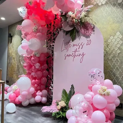 This "Little miss 20 something" theme is perfect for a fun and stylish bachelorette or birthday. The setup features a custom pink arch backdrop, a shimmering sequin wall, and lush pink balloon garlands with floral accents.