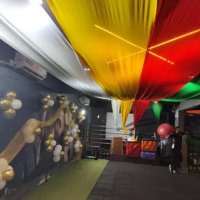 I can decorate any type of venue, including commercial spaces like this gym. For their Dandiya event, I used long drapes of colorful fabric across the ceiling and added balloon clusters to bring a festive feel to the workout area.